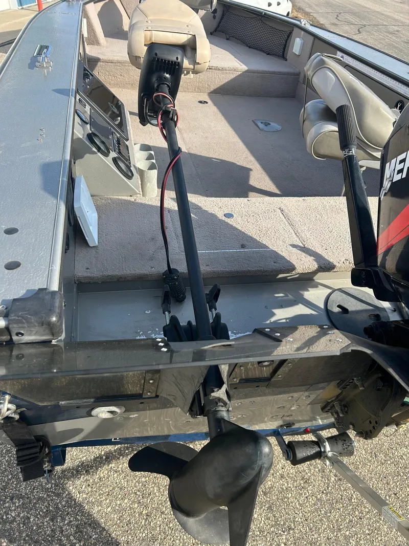 Slide: The Image of 2002 Lund Pro Angler 16 boat interior with motor and seating. - 5