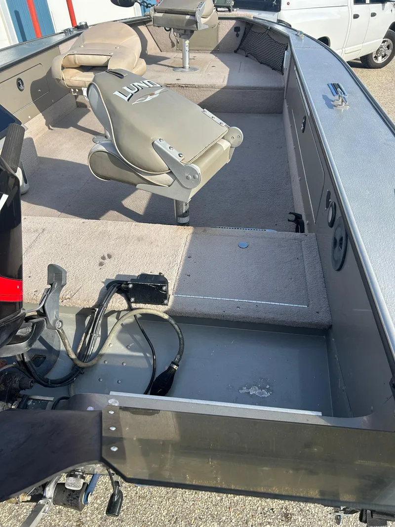 Slide: The Image of 2002 Lund Pro Angler 16 boat interior with seating and storage compartments. - 6
