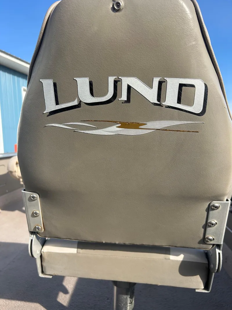 Slide: The Image of 2002 Lund Pro Angler 16 boat seat with logo, outdoor setting. - 7
