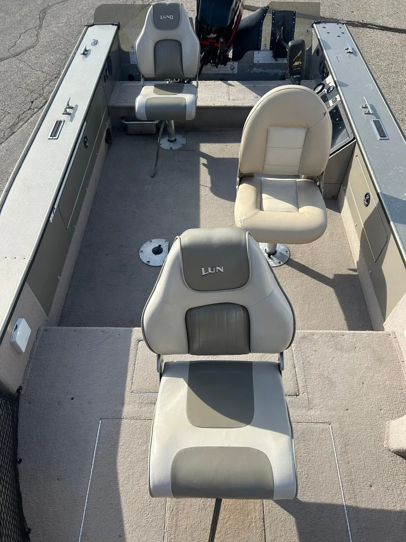 Slide: The Image of 2002 Lund Pro Angler 16 boat interior with three cushioned seats. - 8