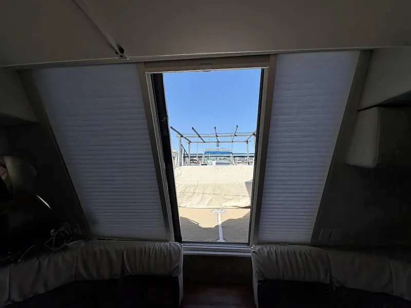 Slide: The Image of Interior view from a 1994 Carver 380 Santego yacht, showing a sunroof and outdoor deck. - 14