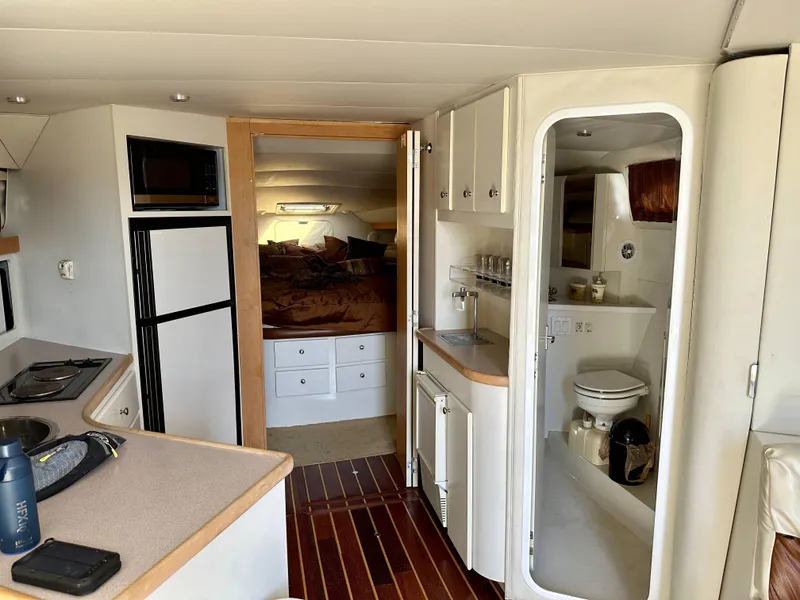 Slide: The Image of Interior of 1994 Carver 380 Santego yacht with kitchen, bathroom, and bedroom. - 15
