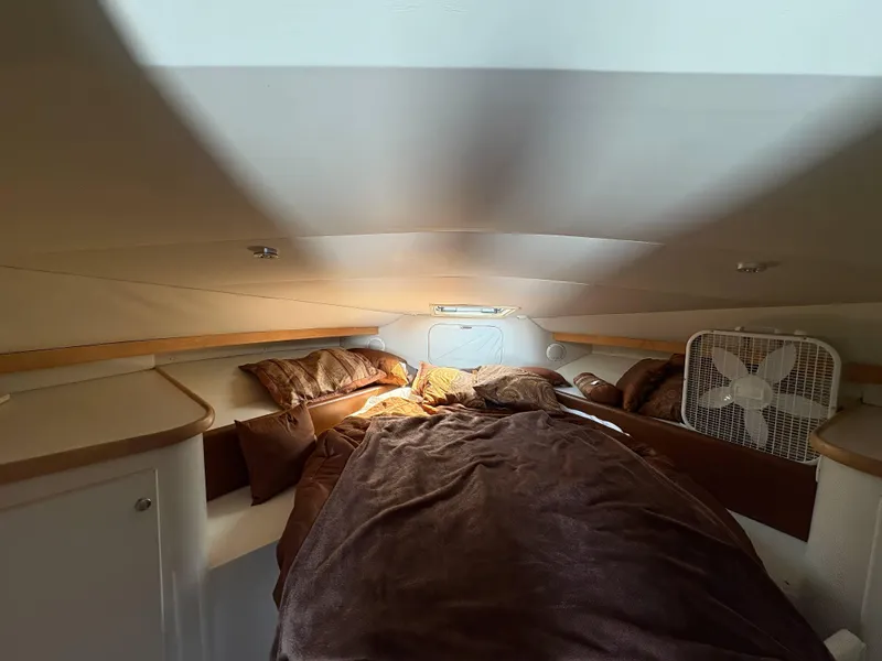 Slide: The Image of Cozy cabin interior of 1994 Carver 380 Santego with bed and fan. - 16