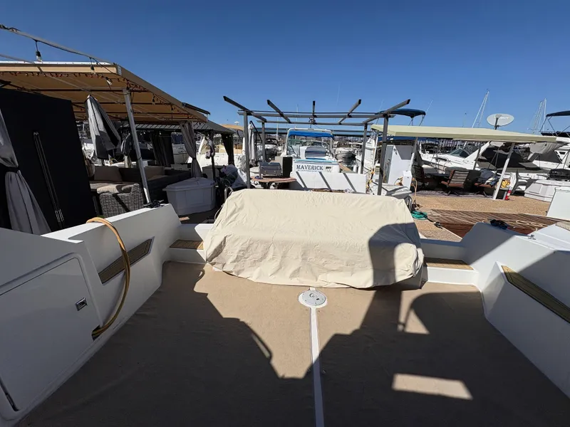Slide: The Image of 1994 Carver 380 Santego yacht docked at marina, covered seating area, clear blue sky. - 17
