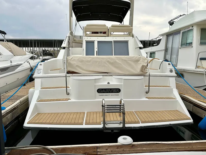 Slide: The Image of 1994 Carver 380 Santego yacht docked at marina, rear view. - 3
