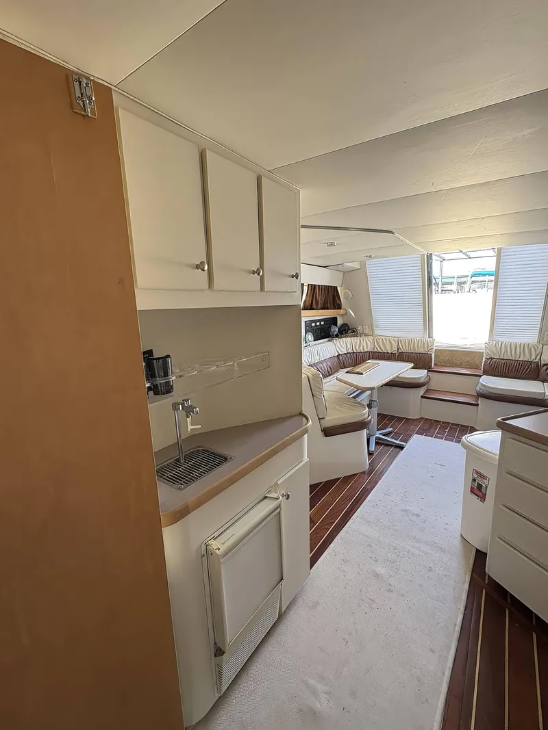 Slide: The Image of Interior of 1994 Carver 380 Santego yacht with seating area and kitchenette. - 6