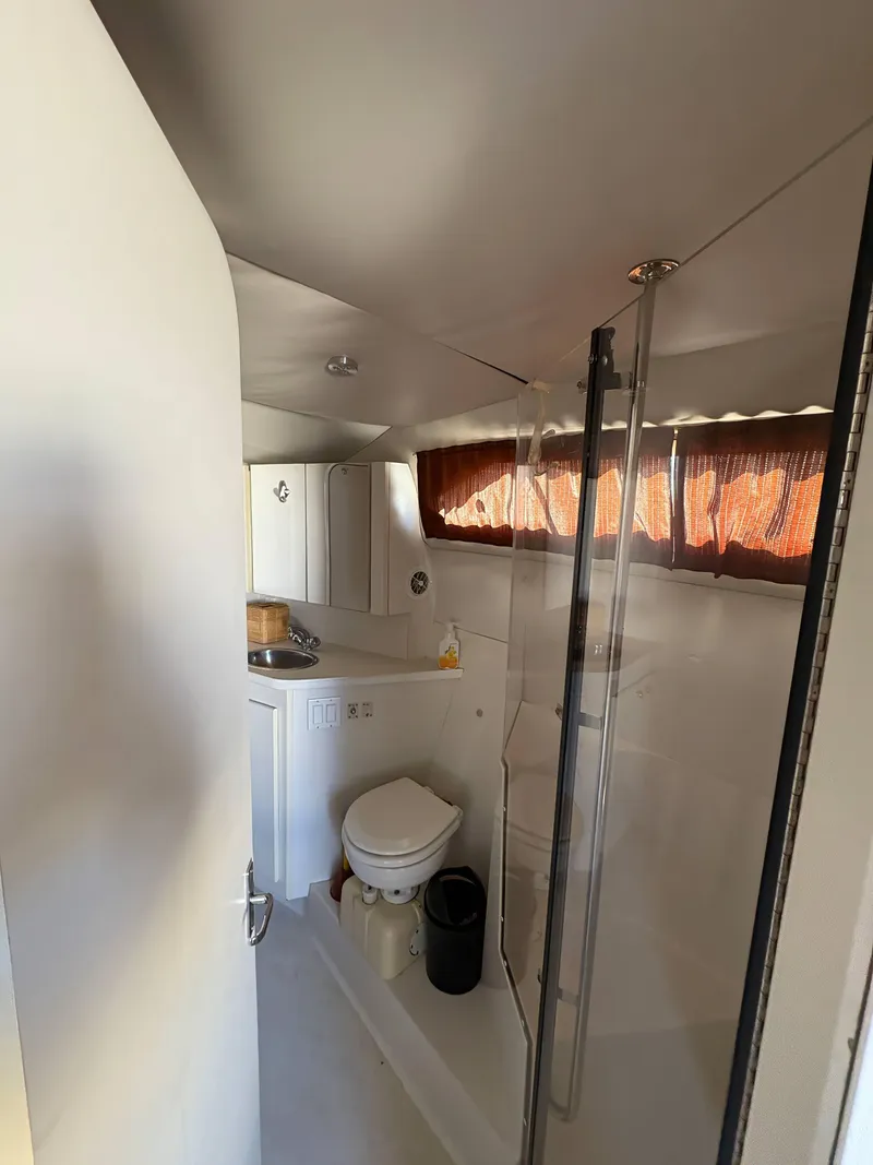 Slide: The Image of 1994 Carver 380 Santego yacht bathroom with shower, toilet, and sink. - 9