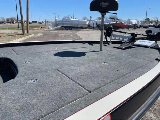 Slide: The Image of 2015 Ranger Z521C fishing boat deck with seating and equipment in a parking area. - 8