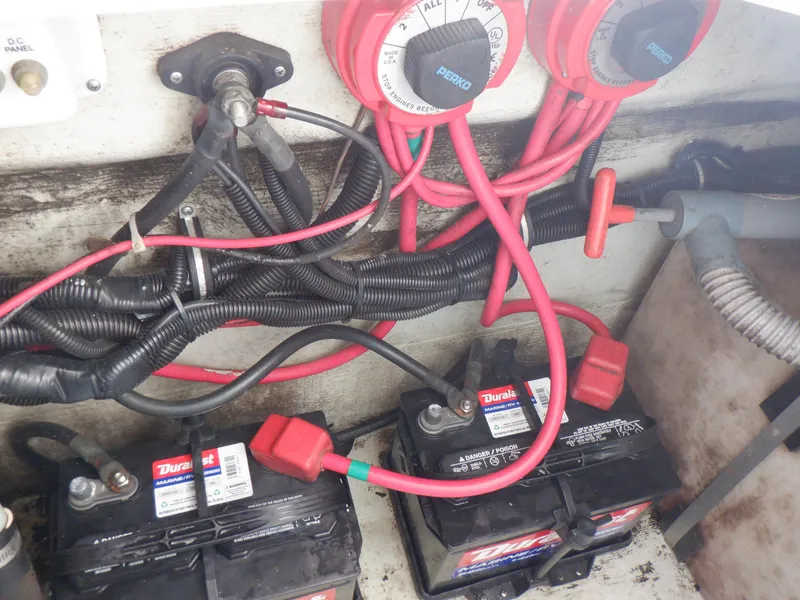 Slide: The Image of Battery setup in a 1999 Pursuit 2870 Walkaround boat with wiring and switches. - 24