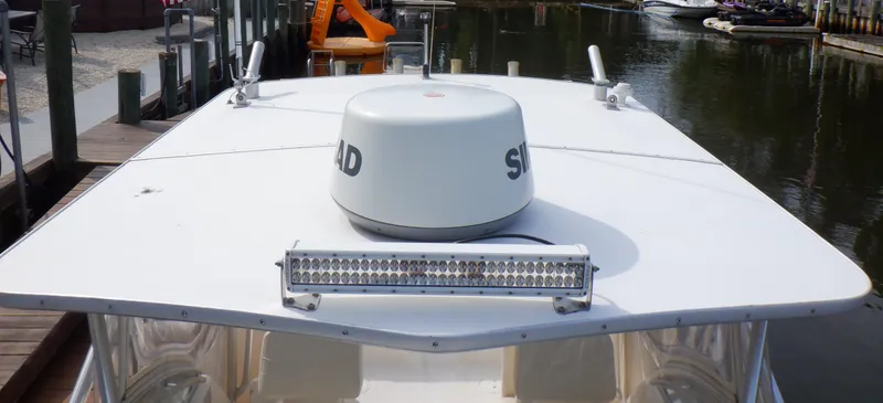 Slide: The Image of 1999 Pursuit 2870 Walkaround boat with radar and light bar on deck. - 25