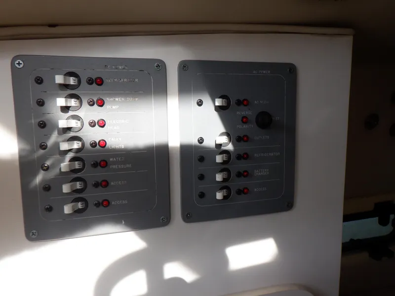Slide: The Image of Control panel of a 1999 Pursuit 2870 Walkaround boat with switches and indicators. - 26
