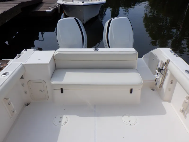 Slide: The Image of 1999 Pursuit 2870 Walkaround boat with dual engines and seating area. - 8