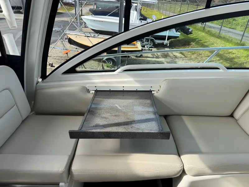 Slide: The Image of Interior of 2022 Boston Whaler 285 Conquest with seating and foldable table. - 18