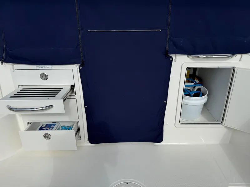 Slide: The Image of 2022 Boston Whaler 285 Conquest interior storage with drawers and compartment. - 22