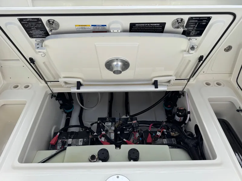 Slide: The Image of Open engine compartment of 2022 Boston Whaler 285 Conquest boat, showing battery and wiring. - 24