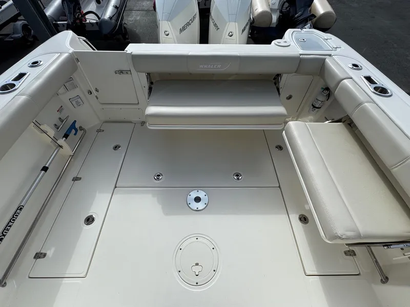Slide: The Image of 2022 Boston Whaler 285 Conquest boat deck with seating and storage compartments. - 25