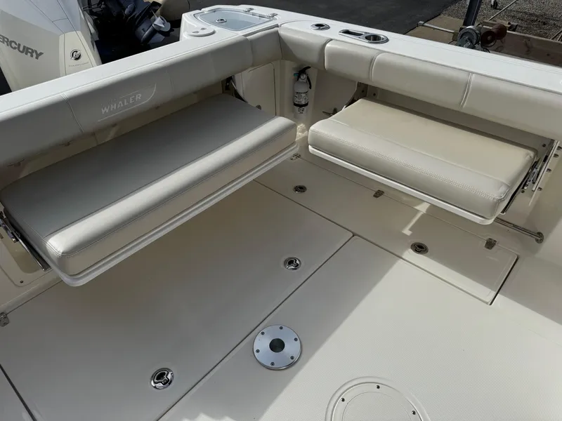 Slide: The Image of 2022 Boston Whaler 285 Conquest boat interior with foldable seating and storage compartments. - 26