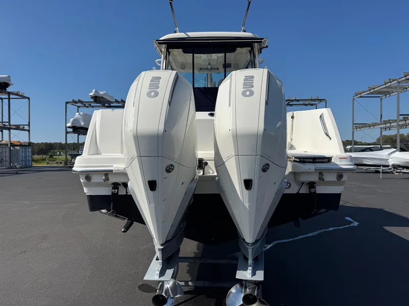 Slide: The Image of 2022 Boston Whaler 285 Conquest with dual outboard engines, rear view. - 4