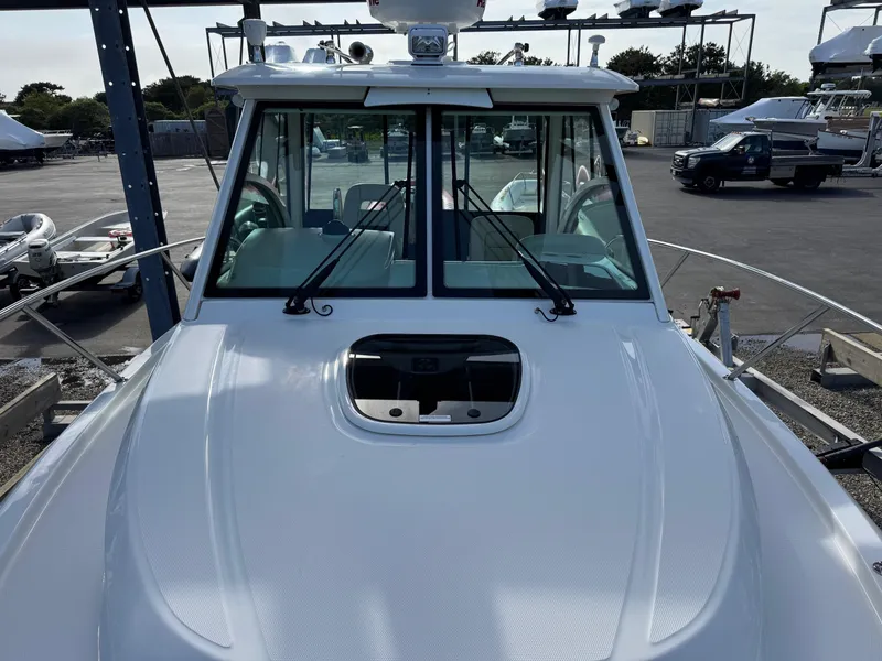 Slide: The Image of 2022 Boston Whaler 285 Conquest boat, front view, docked in a marina. - 7