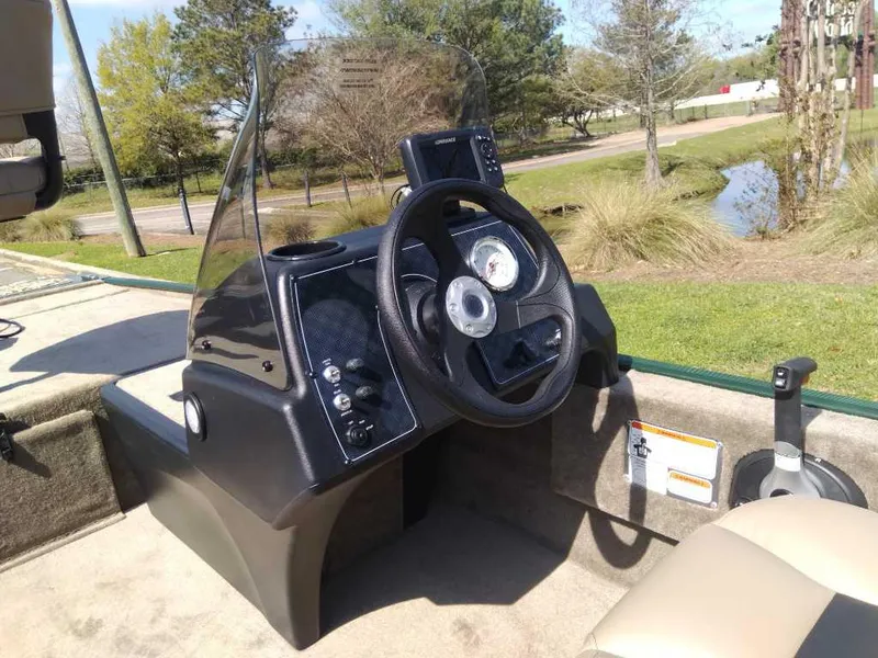 Slide: The Image of 2025 Tracker Bass Tracker Classic Limited boat dashboard with steering wheel and gauges. - 11