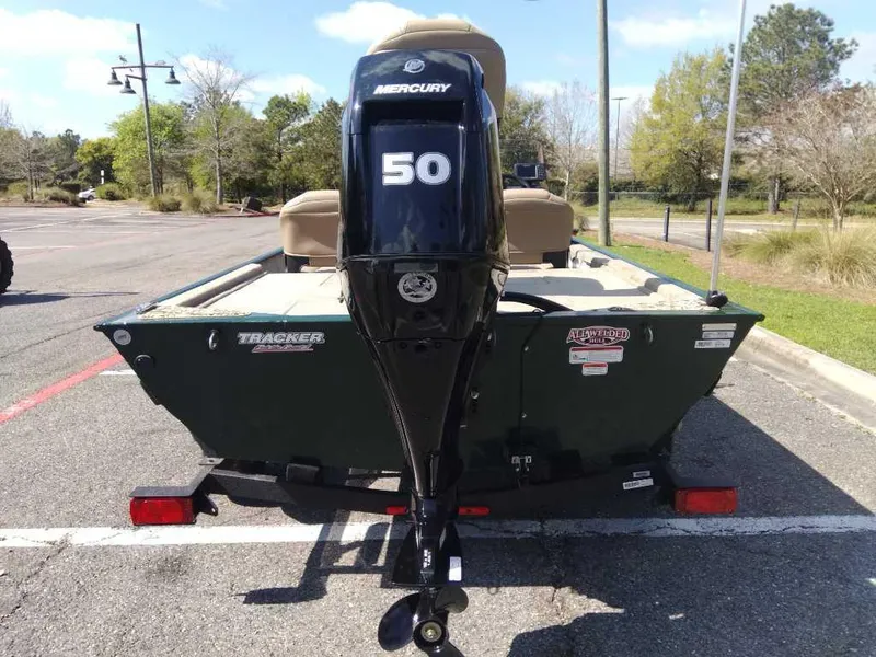 Slide: The Image of 2025 Tracker Bass Tracker Classic Limited boat with Mercury 50 engine in parking lot. - 2