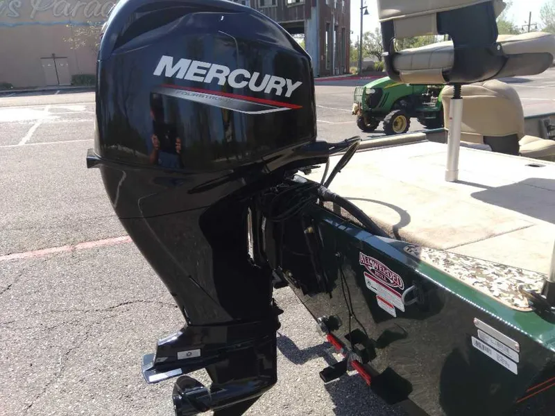 Slide: The Image of 2025 Tracker Bass Tracker Classic Limited with Mercury outboard motor in parking lot. - 3