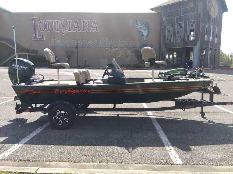 Slide: The Image of 2025 Tracker Bass Tracker Classic Limited boat parked in front of Louisiana building. - 5