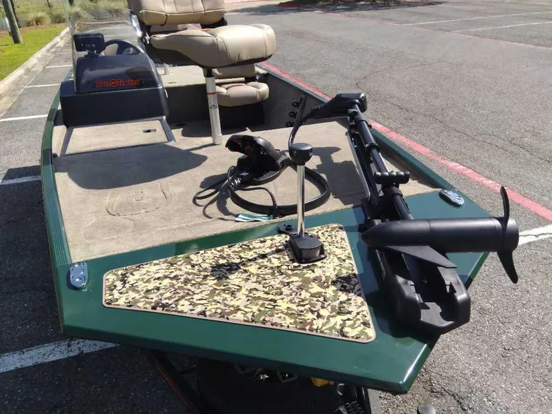 Slide: The Image of 2025 Tracker Bass Tracker Classic Limited boat with camo deck, parked in a lot. - 7