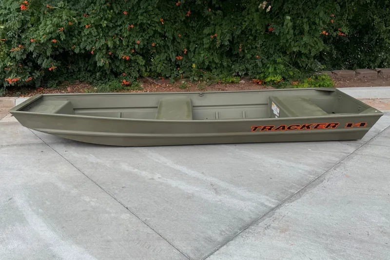 The Image of 2025 Tracker Grizzly 14 Jon boat on concrete, green with orange lettering. - 0