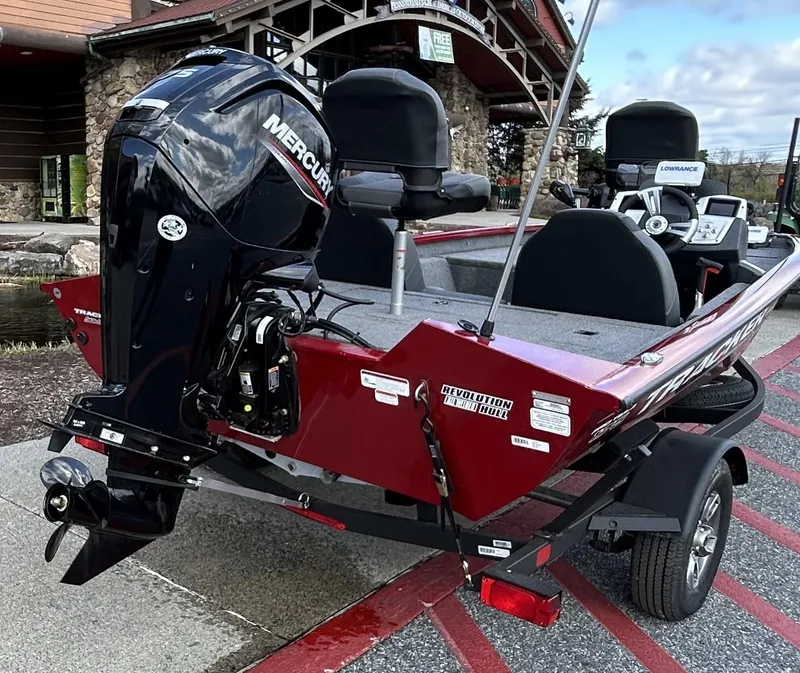 Slide: The Image of 2025 Tracker Pro Team 175 boat with Mercury engine, parked on a trailer. - 2