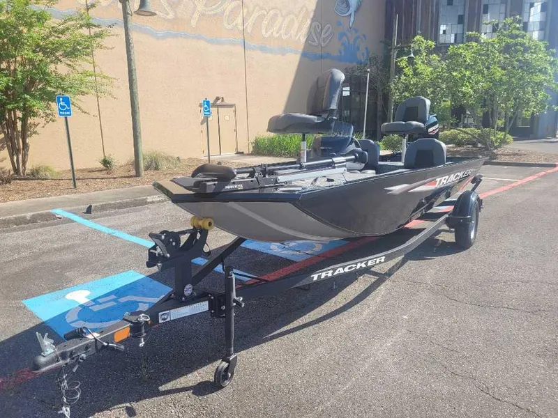 Slide: The Image of 2025 Tracker Pro 170 boat on trailer in parking lot, sunny day. - 3