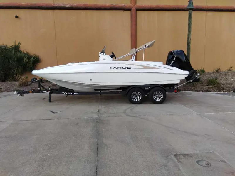 The Image of 2025 Tahoe 2150 CC boat on trailer, parked outdoors. - 0