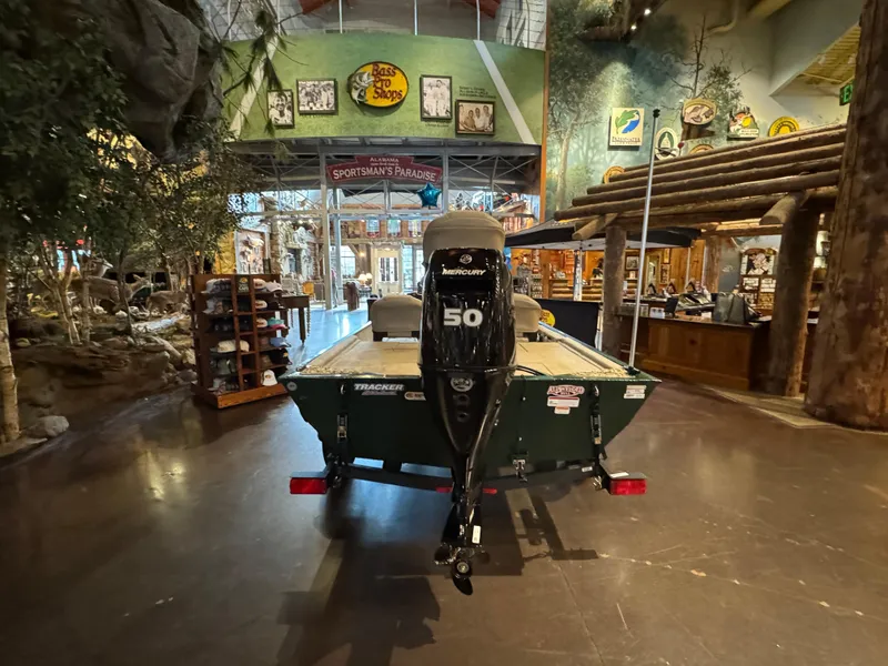Slide: The Image of 2025 Tracker Bass Tracker Classic Limited boat displayed indoors at Bass Pro Shops. - 2