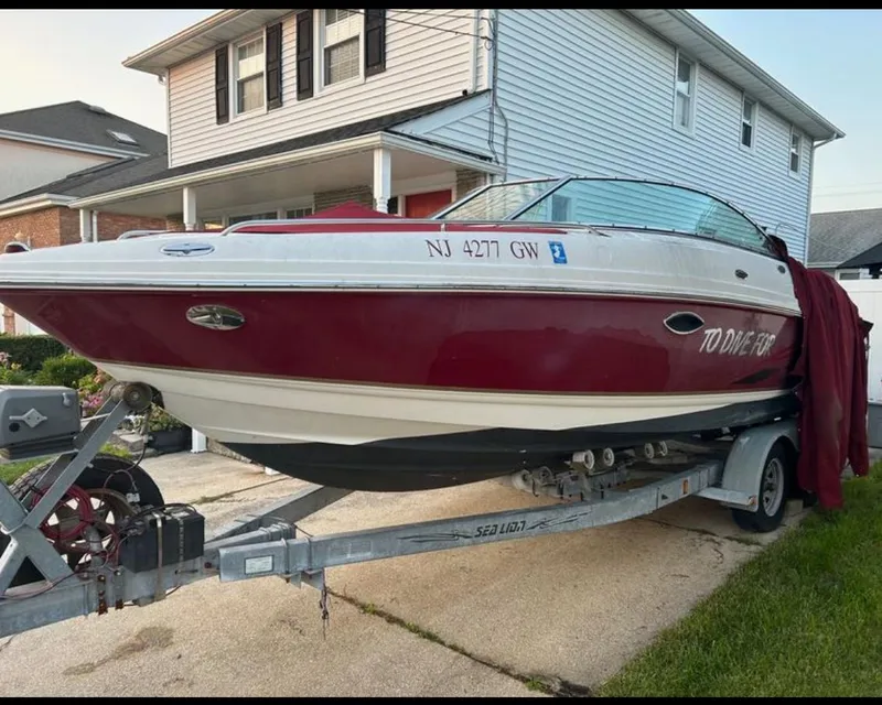 The Image of 2004 Chaparral 230 SSi boat on trailer in residential driveway. - 0