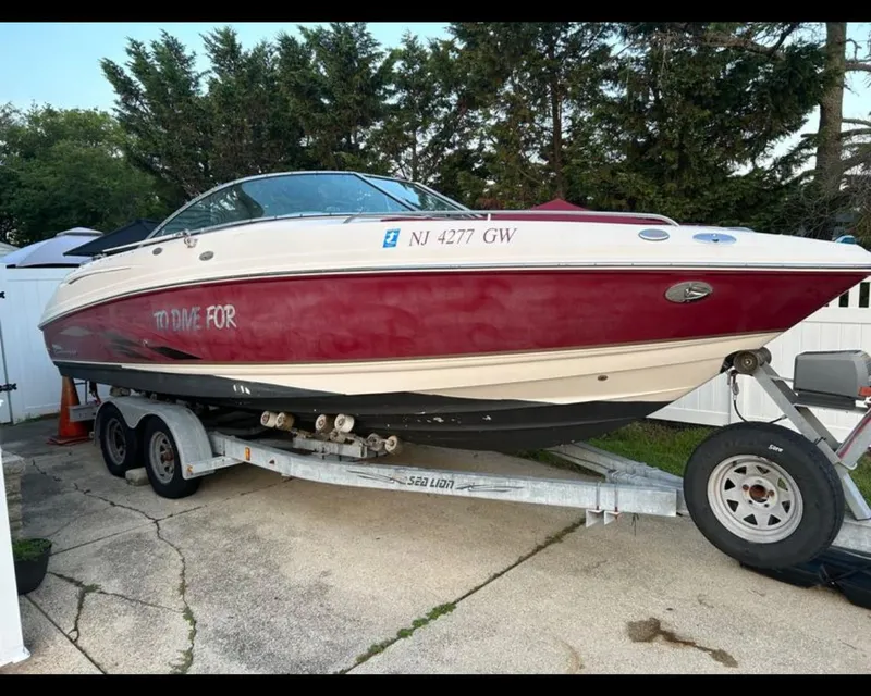 Slide: The Image of 2004 Chaparral 230 SSi boat on trailer, red and white, parked outdoors. - 4