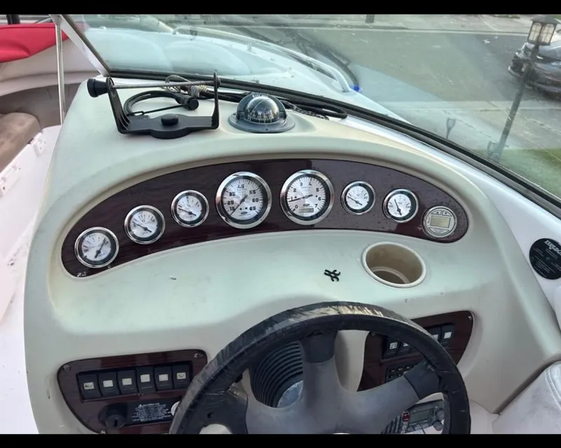 Slide: The Image of Dashboard of a 2004 Chaparral 230 SSi boat with gauges and steering wheel. - 6