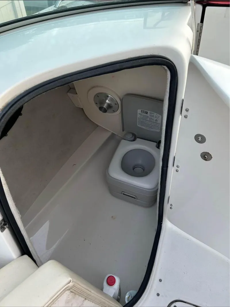 Slide: The Image of 2004 Chaparral 230 SSi boat interior with compact marine toilet. - 7
