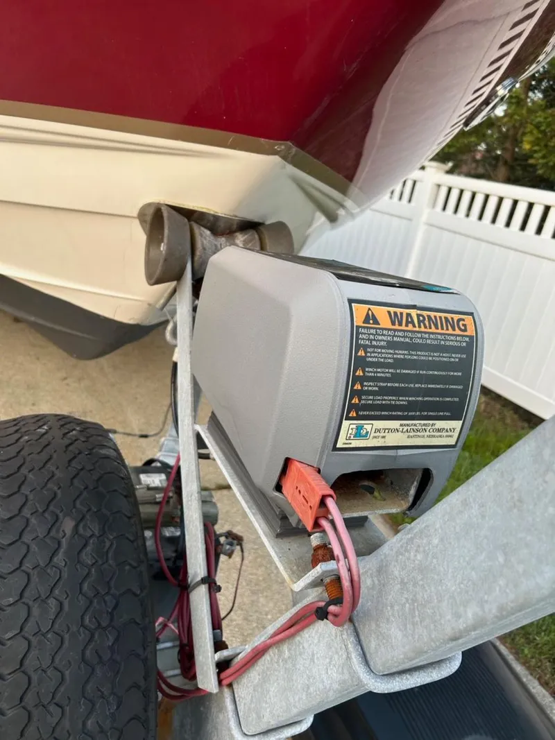 Slide: The Image of 2004 Chaparral 230 SSi boat trailer with warning label and red hull detail. - 9