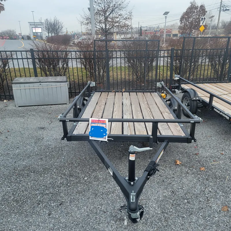 The Image of 2024 Tracker KTO-2000-60-8 utility trailer with wooden deck, displayed outdoors. - 0