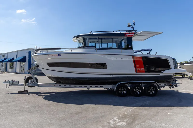 Slide: The Image of 2022 Jeanneau NC Sport 895 boat on trailer, side view, sunny day. - 0