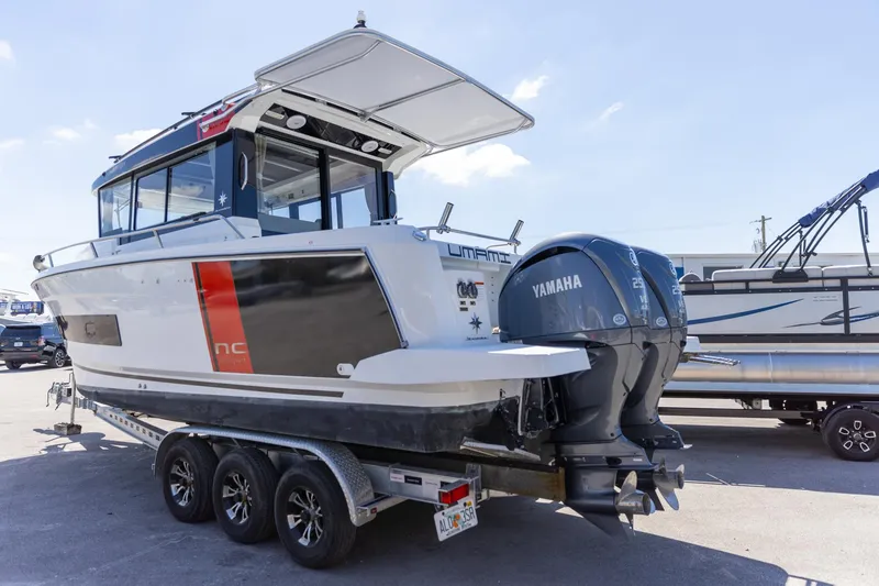 Slide: The Image of 2022 Jeanneau NC Sport 895 boat with Yamaha engines on a trailer. - 12