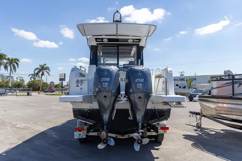 Slide: The Image of 2022 Jeanneau NC Sport 895 boat with dual 250 V6 engines, parked outdoors. - 13