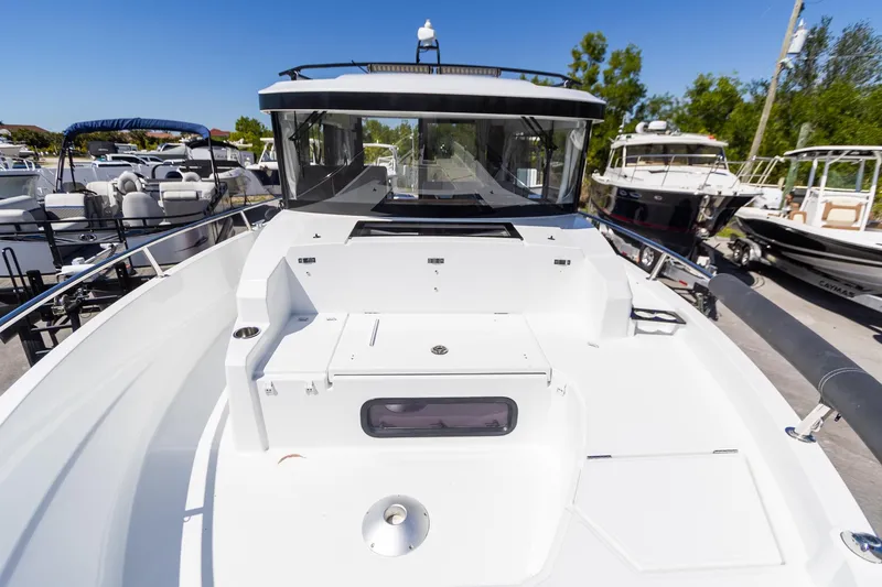 Slide: The Image of 2022 Jeanneau NC Sport 895 boat, docked, showcasing spacious deck and sleek design. - 19