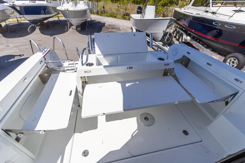 Slide: The Image of 2022 Jeanneau NC Sport 895 boat interior with seating and storage compartments. - 2