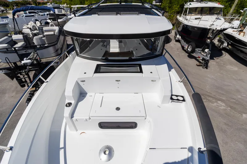 Slide: The Image of 2022 Jeanneau NC Sport 895 boat, sleek design, docked in marina. - 20