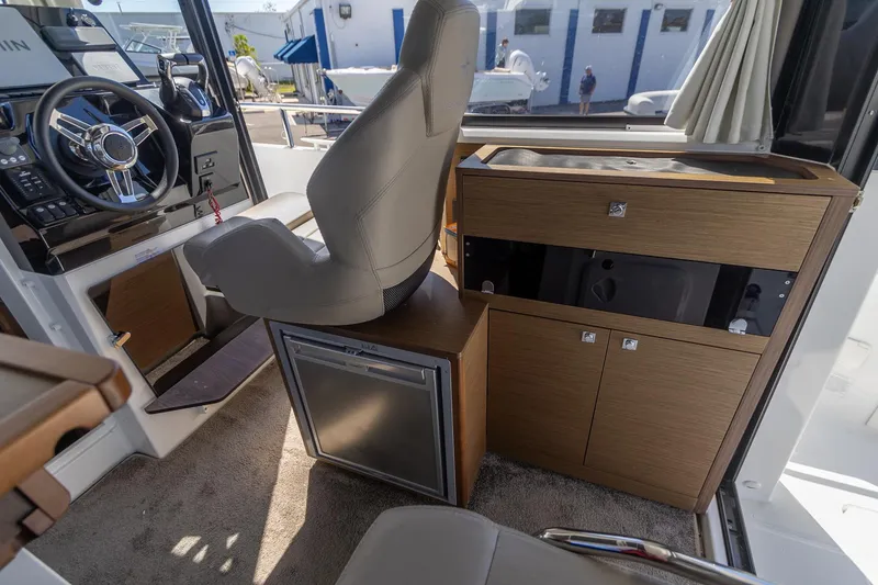 Slide: The Image of Interior of 2022 Jeanneau NC Sport 895 boat with helm and cabinetry. - 23