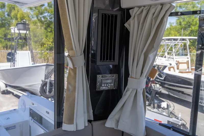 Slide: The Image of Interior view of 2022 Jeanneau NC Sport 895 with curtains and control panel. - 27