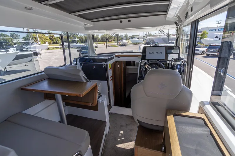 Slide: The Image of Interior of 2022 Jeanneau NC Sport 895 boat with modern seating and navigation equipment. - 3