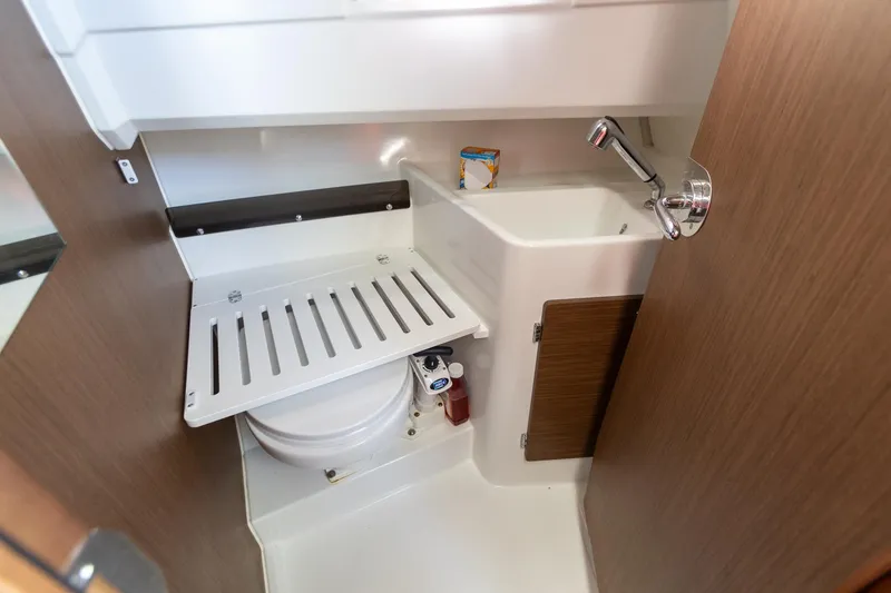 Slide: The Image of 2022 Jeanneau NC Sport 895 bathroom with compact sink and storage. - 4