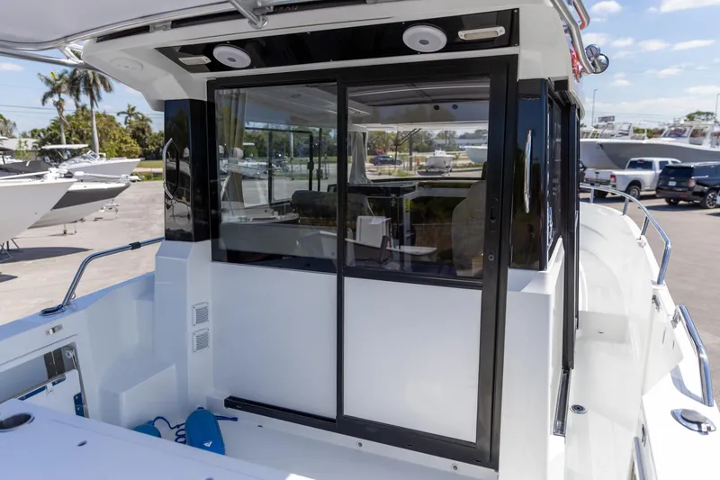 Slide: The Image of 2022 Jeanneau NC Sport 895 boat with sliding glass doors and spacious deck. - 7